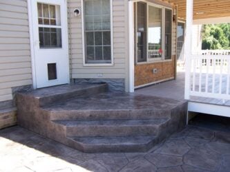 Random Stone stamped concrete job by Interscope Contractors Random Stone stamped concrete patio and stairs leading up to house