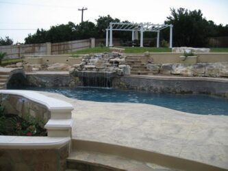 Old Granite Seamless job by Zeevaert Pools multilevel pool and hot tub with stamped concrete decking