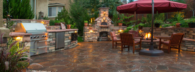 Stamped Concrete Patio with Outdoor Kitchen, Fireplace, and Seating